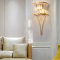 DecorBites™ Golden Curved Metal Wall Sconce with Clear Crystal Prism