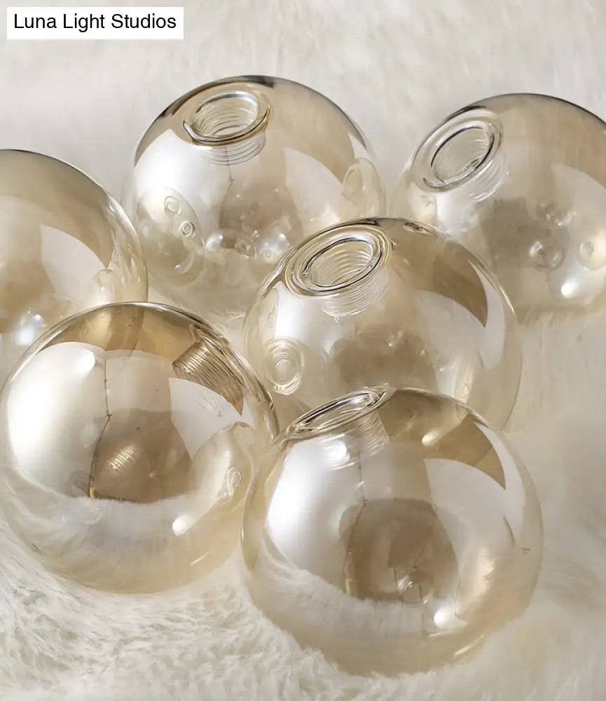 DecorBites™ Mid-Century Modern Gold Metal Pendant with Spherical Amber Glass - Island Ceiling Light for Dining Table