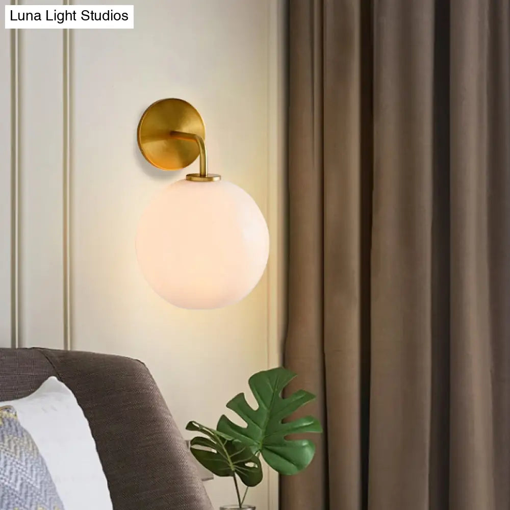 DecorBites™ Modern Glass Orb Wall Sconce with Brass Arm, Clear/White