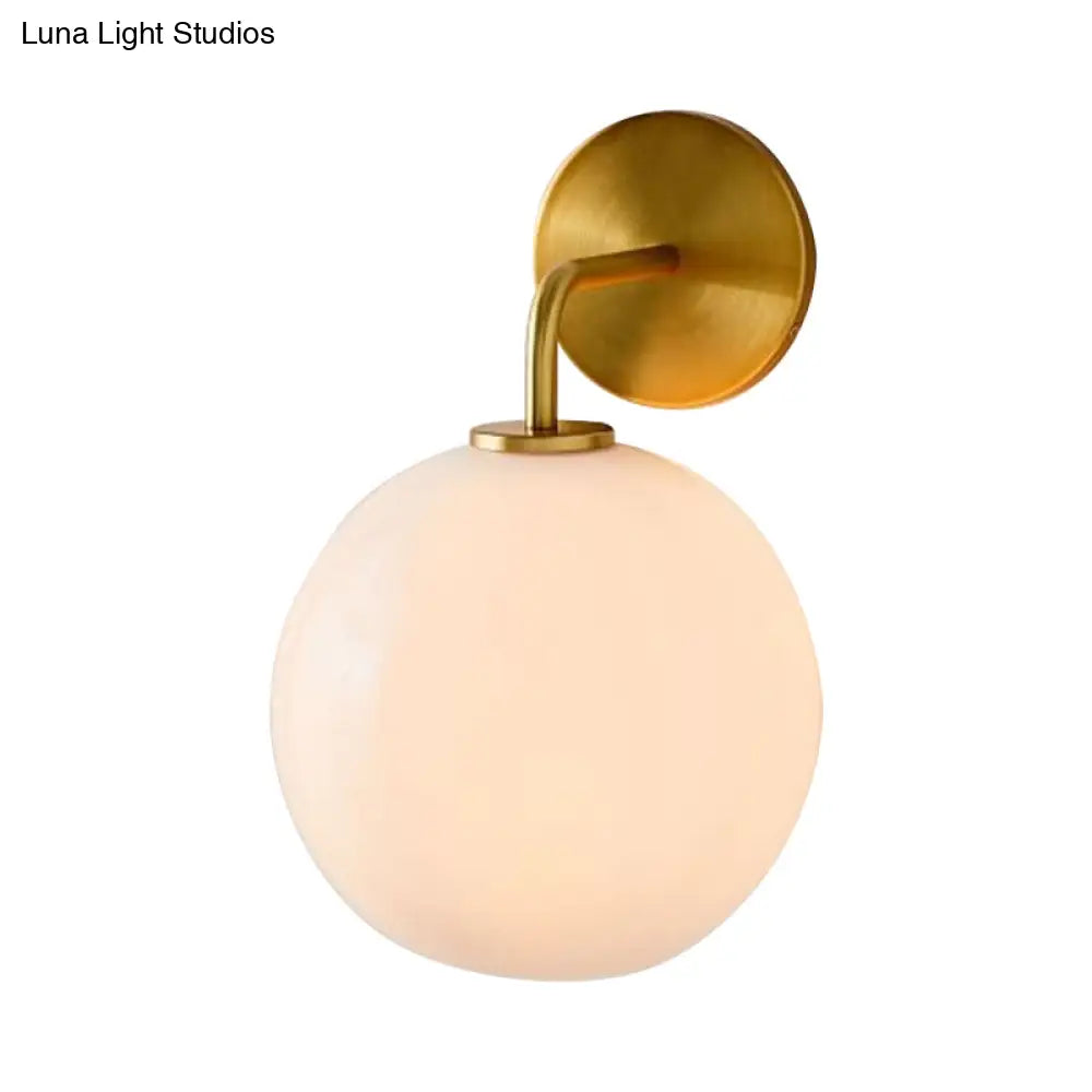 DecorBites™ Modern Glass Orb Wall Sconce with Brass Arm, Clear/White