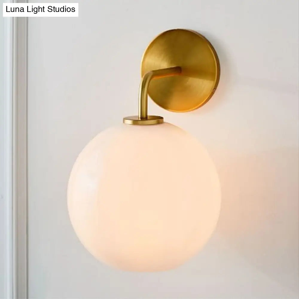 DecorBites™ Modern Glass Orb Wall Sconce with Brass Arm, Clear/White